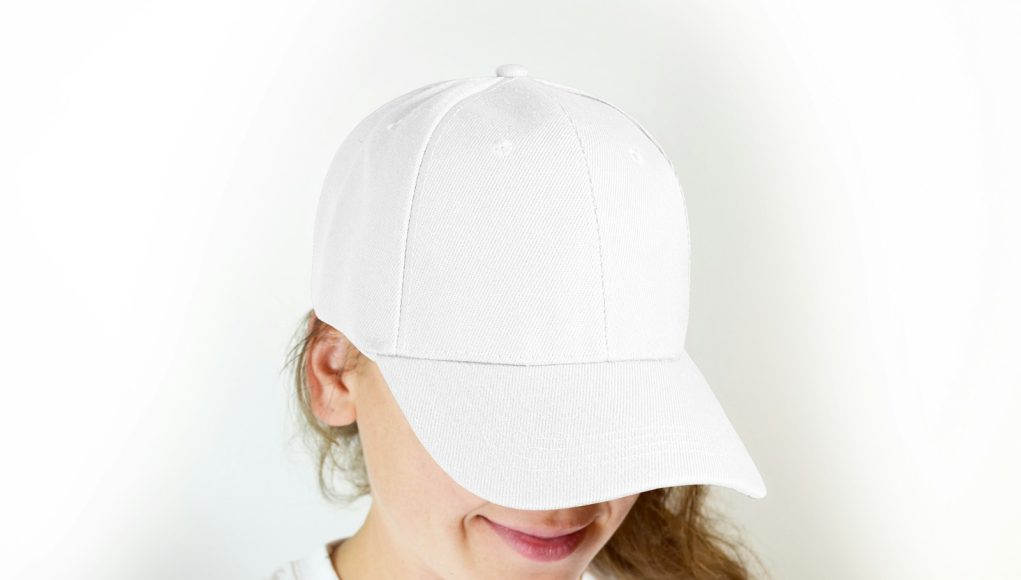 woman in white crew neck shirt wearing white cap