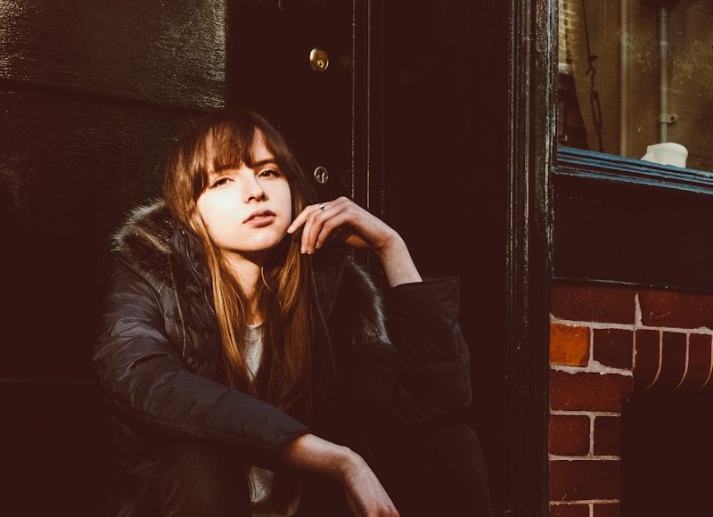 woman sitting near door