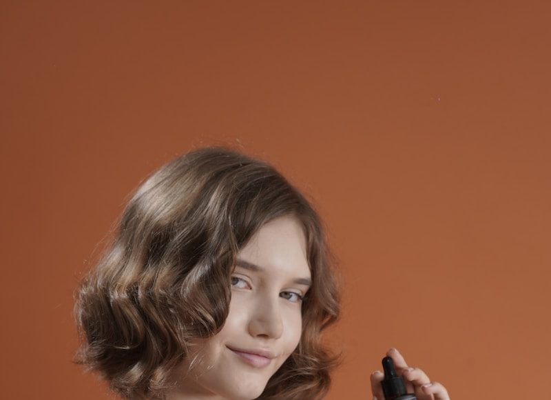Young woman holds a skincare product bottle.