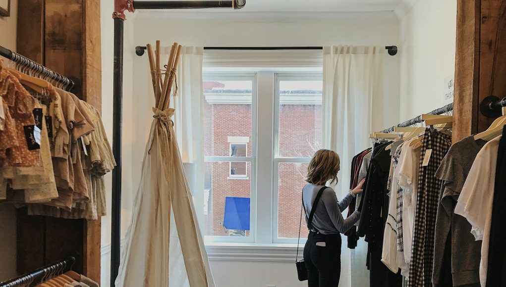 woman standing selecting clothes