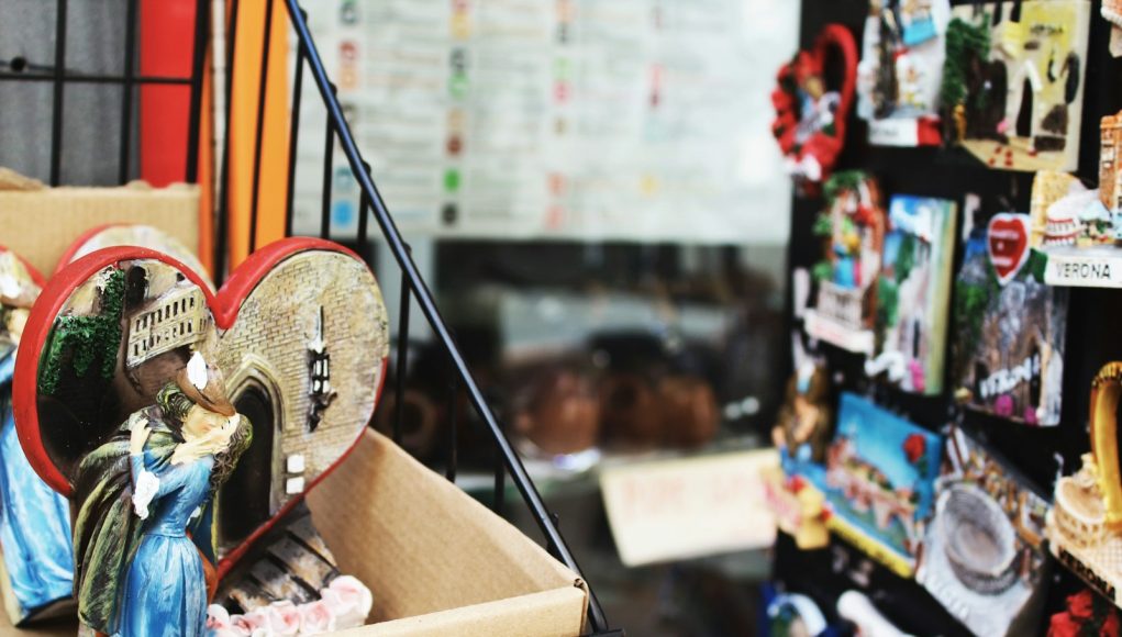 couple kissing figurine on top of rack near display of product packs