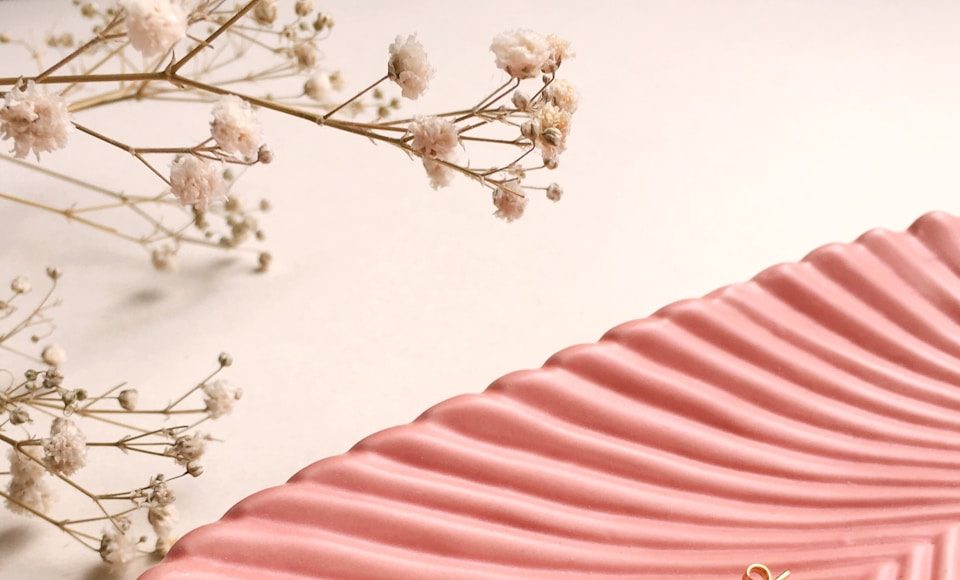 gold and silver rings on pink and white striped textile