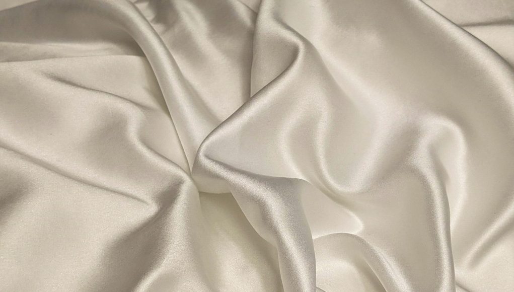 white textile on brown wooden table
